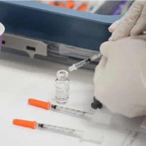 Vial of Botox being loaded into syringes for treatment